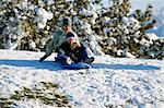 Mother and Son Sledding down the Hill - Winter Scenes