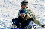 Mother and Son Sledding down the Hill - Winter Scenes