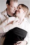 Studio portrait of a young amorous couple holding hands