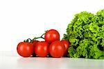 Healthy lettuce and tomatos over a white table