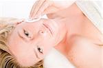 Studio portrait of a spa girl cleaning her face