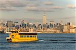 Liberty State Park Ferry on Hudson River with Mid-Town Manhattan in the background.