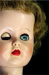 Close up of a winking doll's face