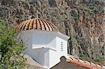 The tiled dome of a white church in the castle-town of Monemvasia, Greece