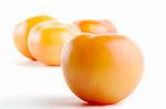 Four tomatoes, One sharp in the foreground, with three out of focus in the background