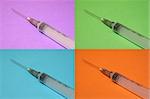 4 Syringes on different colored backgrounds