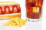 Hot dog, soda glass and french fries, reflected on white background. Shallow DOF