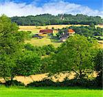 Scenic view on summer agricultural landscape in rural France with a farmhouse and barn