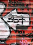 an image of red, white and black graffiti on a shop window