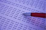 Pen checking numbers on a financial report - Blue tone and blur effect