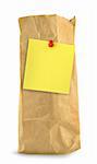brown paper bag with yellow note against white background, small shadow at the left side