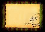sheet of old paper with part of music note, all against grunge dark background