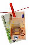 Euro banknotes held by a clothesline. Isolated on a white background.
