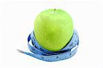 Granny Smith apple with a measuring tape isolated on a white background