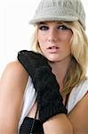 Face of a cute blond hair young woman wearing funky wool hat and black arm coverings for a funky style on white