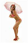 Full body of a beautiful blond hair woman wearing polka dot red bikini holding a matching umbrella with matching headband standing on white