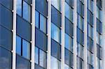 sky reflection on front side of the office building