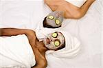 Two girls are relaxing during facial mask application in spa