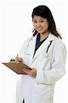 Female attractive Asian doctor wearing white lab coat holding a clipboard chart with a stethoscope around shoulders smiling standing on white background