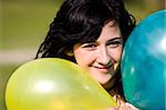 Cute girl between two colored balloons