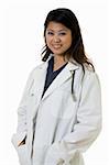 Female attractive Asian doctor wearing white lab coat with hands in pockets wearing a stethoscope around shoulders smiling standing on white background