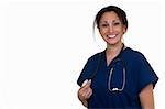 Confident woman healthcare worker wearing dark blue scrubs holding the end of a stethoscope on white
