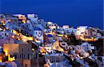 Image shows the village of Oia at dusk, on the beautiful island of Santorini, Greece