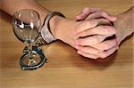 alcohol addiction, hands handcuffed with an epmty alcohol glass