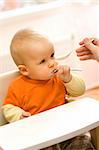 Feeding procedure of a little baby boy - he uses an extra spoon