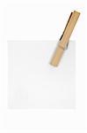 Blank note held by a wooden clothespin. Isolated on a white background.