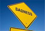 Sadness road sign with deep blue sky background. Contains clipping path.