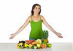Beautiful and healthy woman with a lot of fruits in front of her