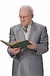 Senior man reading a book against a white background.Shot with Canon 70-200mm f/2.8L IS USM