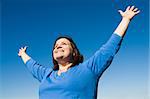 Beautiful plus sized model celebrating her freedom as she exercises outdoors.