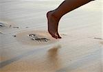 Image of foot prints and legs on beach