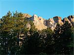 Mount Rushmore National Memorial seen through trees.