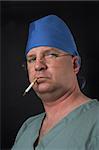 A medical surgeon smoking an unhealthy cigarette.