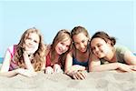 Portrait of four young girls on a sandy beach