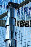 Complex of office buildings with mirror walls in which the sky is reflected