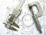 Engineering tools on technical drawing. Digital caliper and micrometer.