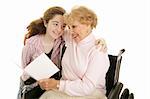 Grandmother and teen girl reading a get well card or mothers day card together.  Isolated on white.