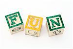 word fun formed by alphabet wood blocks on a white surface