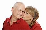 Happy middle aged man receiving a kiss from his wife.  Isolated on white.