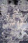 A section of an old distressed and eroded gravestone from the 1600's.  Background image for Halloween or anything spooky.  Scanned film.