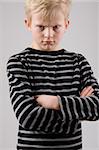 Portrait of a angry little boy posing on white background