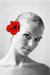 beauty portrait of a beautiful young woman with a flower on her face