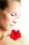 isolated beauty portrait of a young woman with a red flower