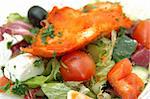 Close up of greek salad with chicken tikka
