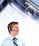 Young businessman with headphones , cell keyboard in macro and light streaks