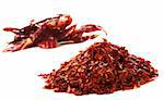 pile of Hot Red Chilli Chillies pepper, dried and crushed. Second pile of Whole chillies on background. Shallow DOF, isolated on white